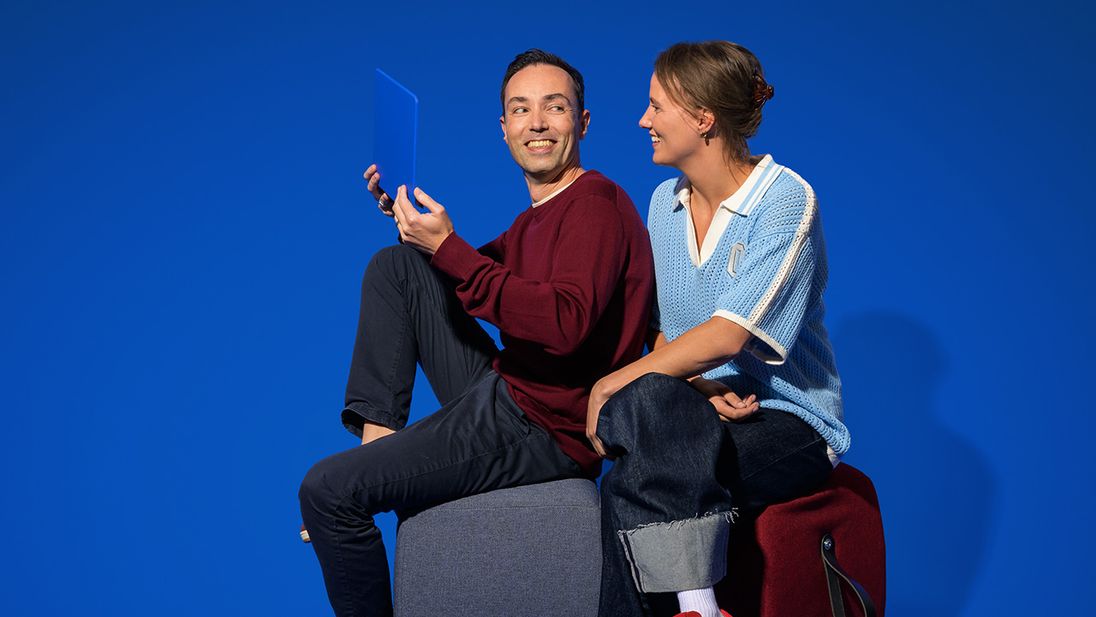 Twee Lidl kantoormedewerkers die samen achter een laptop zitten