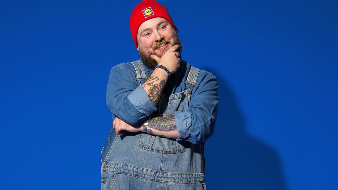Lidl supply chain management medewerker staat met een Lidl beanie op