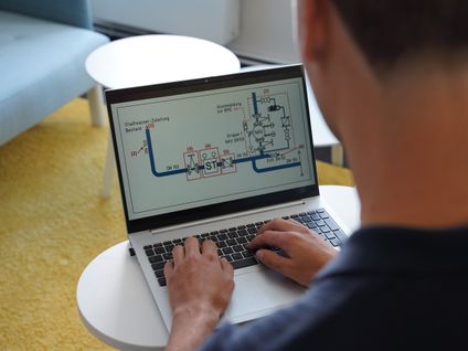 Dualer Student bei Kaufland arbeitet am Laptop und betrachtet Lerninhalte aus dem Studiengang Bauingenieurwesen.