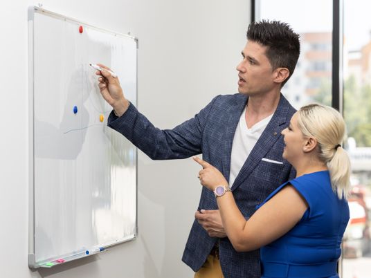 two colleagues with a whiteboard