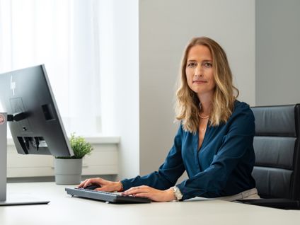 Manažérka oddelenia Business Intelligence sedí za stolom v office pri desktope